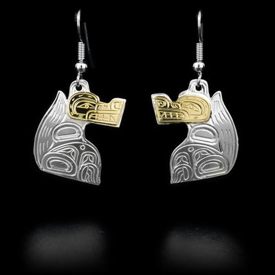 Each dangle earring features a wolf with a 14K yellow gold face. Hand-carved by Kwakwaka’wakw artist William Cook.