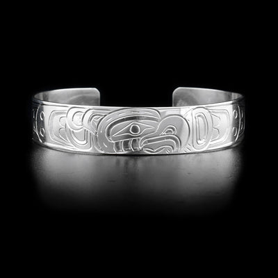 Bracelet with thunderbird head facing left on front and body on sides. Hand-carved by Kwakwaka’wakw artist William Cook.
