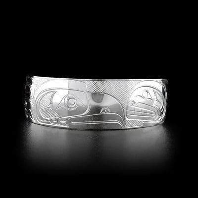 Sterling silver eagle and orca cuff bracelet. Three quarters of an inch wide. Meticulously hand-carved by Coast Salish artist Travis Henry.