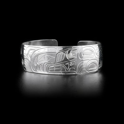 Bracelet with wolf head facing left on front and body on sides. Hand-carved by Kwakwaka’wakw artist William Cook.