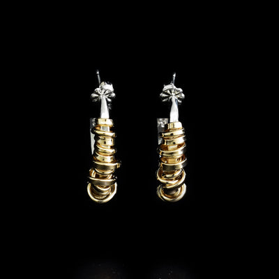 Sterling silver wavy hoop studs with gold-fill coil wrapped all along front.