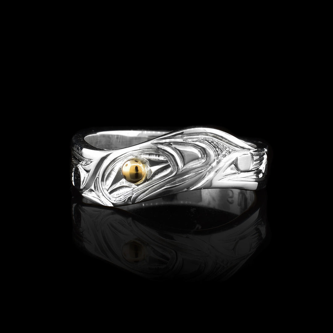 Silver and Gold Wavy salmon ring with 14k gold used for the eye the rest of the ring is carved into the legend of the indigenous salmon legend. The classic band has been molded with a unique wave to ad a modern touch.