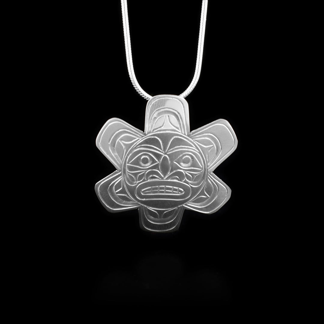 This sterling silver Sun pendant is shaped like and has carvings on the surface of it depicting the Sun.