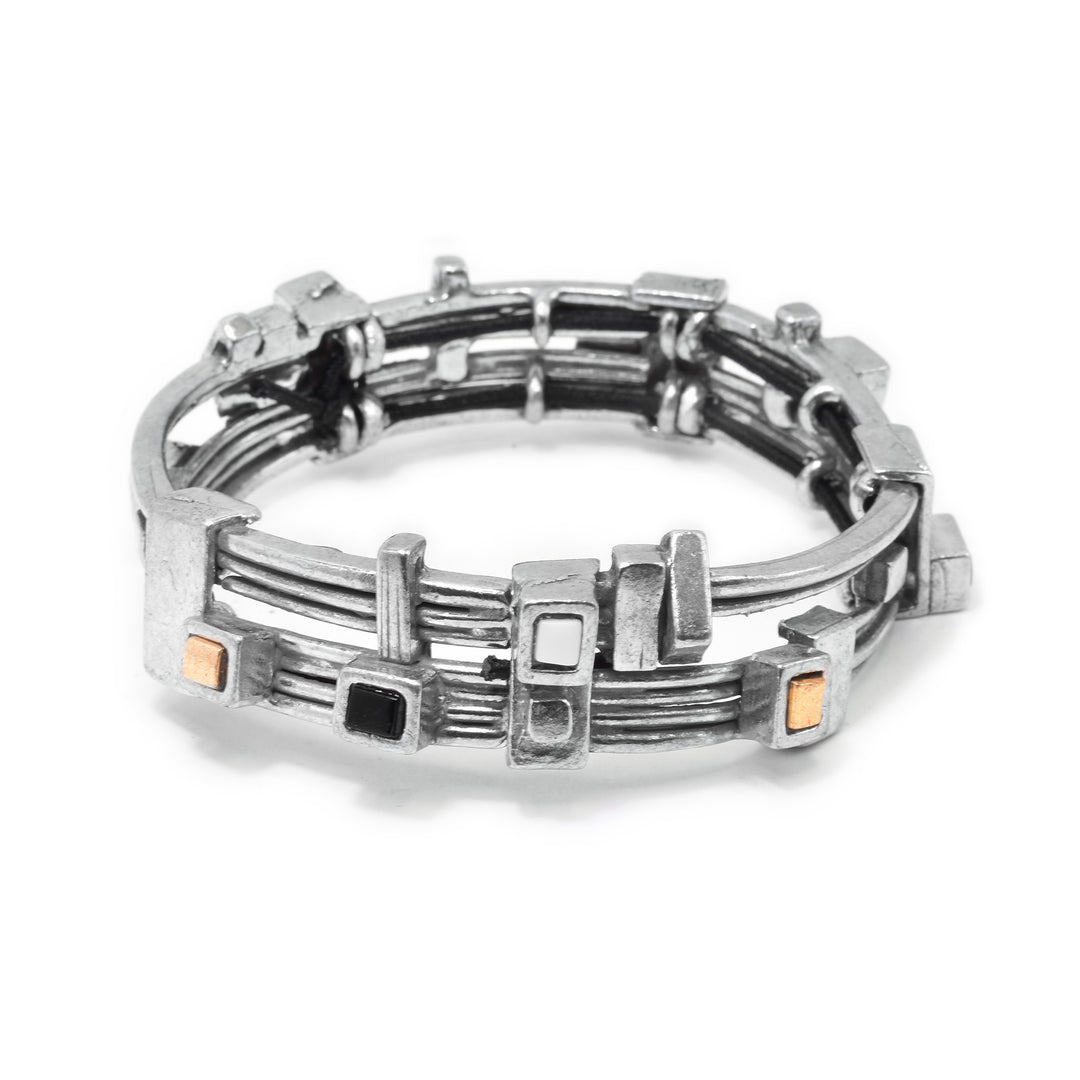 This glass bangle bracelet has thin, pewter bands that are stacked on each other. There are two, separate bands that are made from four thin bands each to make this piece. There are gold plated cubes, as well as black and white glass ones that are framed in pewter around the band.
