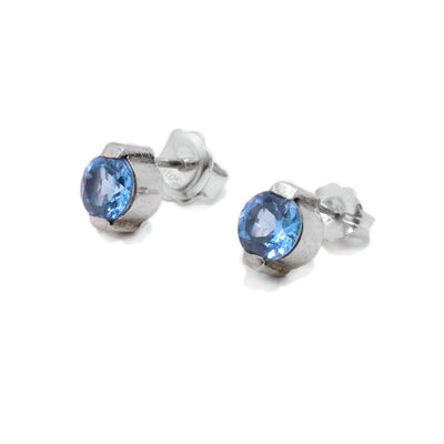 Round, petite, faceted blue topaz stud earrings handcrafted by Ivan Dobren.
