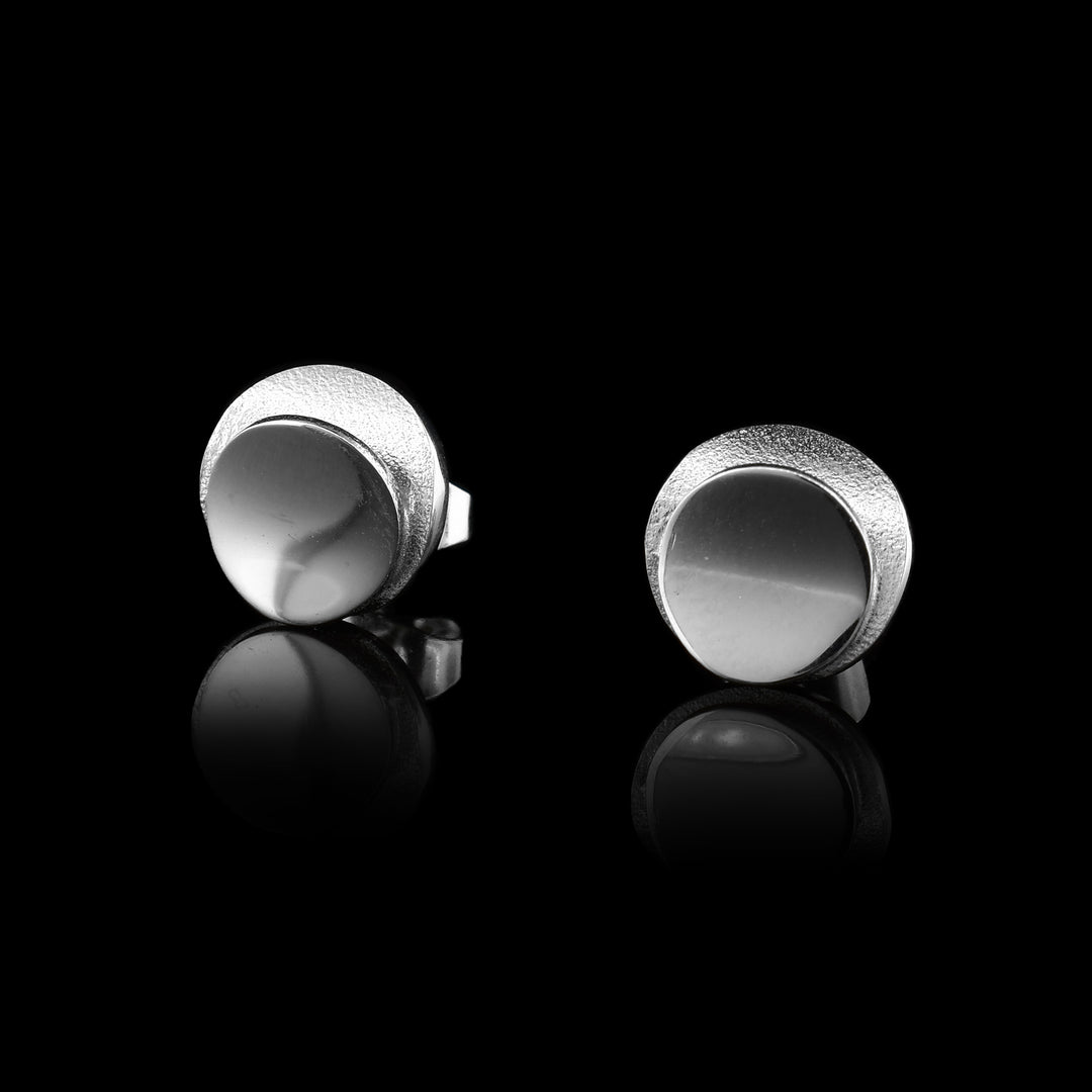 Sterling Silver Circle Studs. a smooth circle of silver in the middle surrounded by a frame of matte silver.
