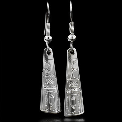 These dangle earrings are made out of sterling silver and are shaped like a long triangle. The Orca is carved at the bottom of the earrings, and is facing downwards.