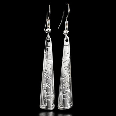 These dangle earrings are carved out of sterling silver. The tringular earrings have a face of the Eagle carved on the bottom, looking downward.