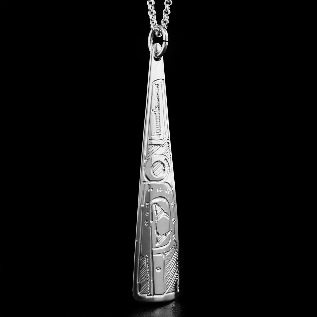 This sterling silver Hummingbird pendant has a long triangle shape and has the face of the Hummingbird handcarved on it, facing downwards.