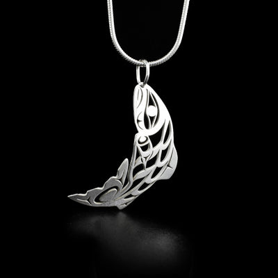 This salmon pendant depicts a full-bodied salmon with the bail going through its mouth as if it has been hooked. Parts of it have been cutout for detail and depth.