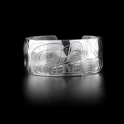 Bracelet features bear head facing left on front. Hand-carved by Kwakwaka'wakw artist William Cook.