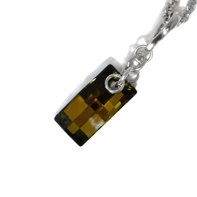 Rectangular bronze Swarovski crystal hangs below interconnected sterling silver ring adornments leading up to bail. Pendant measures 2” x 0.5” including bail.