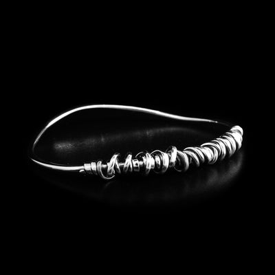 Wavy sterling silver bangle with sterling silver coil wrapped around front. By artist Joy Annett.
