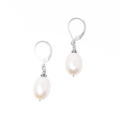 Lever-back earrings with vertical oval freshwater pearls. Pearls are framed by oxidized silver adornments on top. Each earring measures 1.38” x 0.38” including hook.