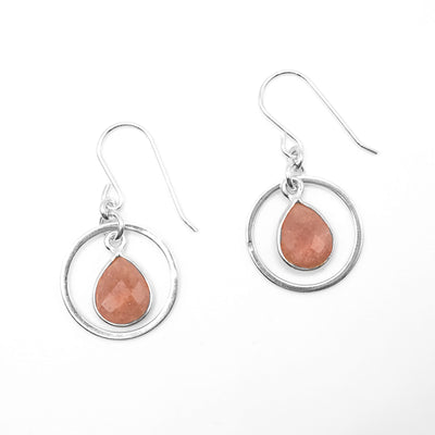 Dangle hoop earrings with flat, faceted strawberry quartz teardrops dangling in hoops. Metal is sterling silver.