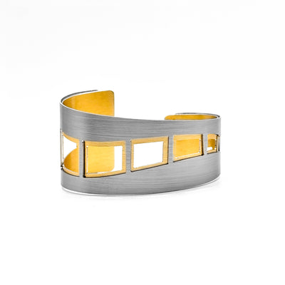 Tapered brushed and anodized aluminum cuff bracelet. 1.5” at widest and 0.75” at slimmest. By JR Franco.