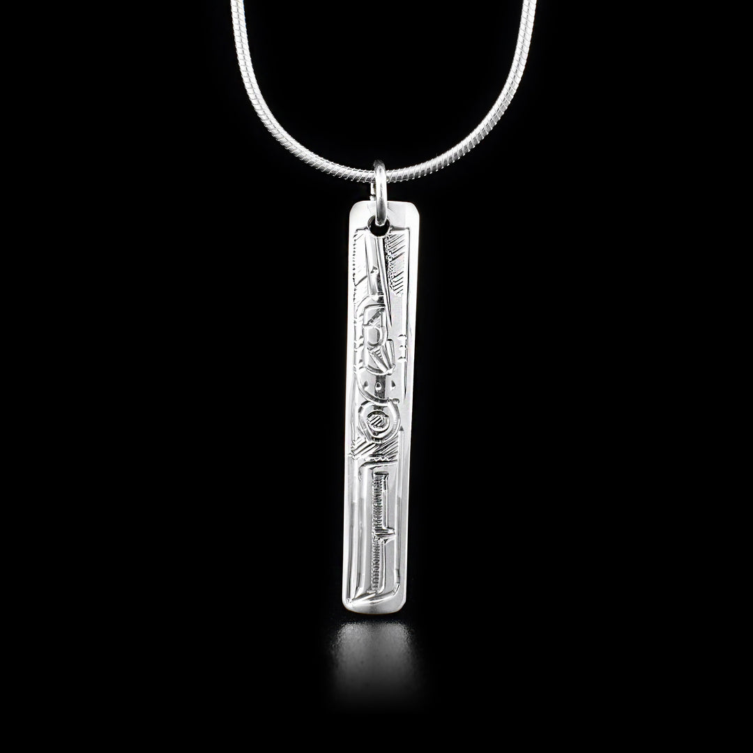 Long, thin sterling silver rectangle pendant depicting hummingbird.