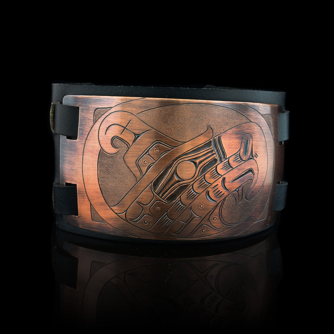 Thunderbird leather and copper bracelet the copper plate has been carved with the legend of the thunderbird. The cuff is made with authentic leather for easy comfort.