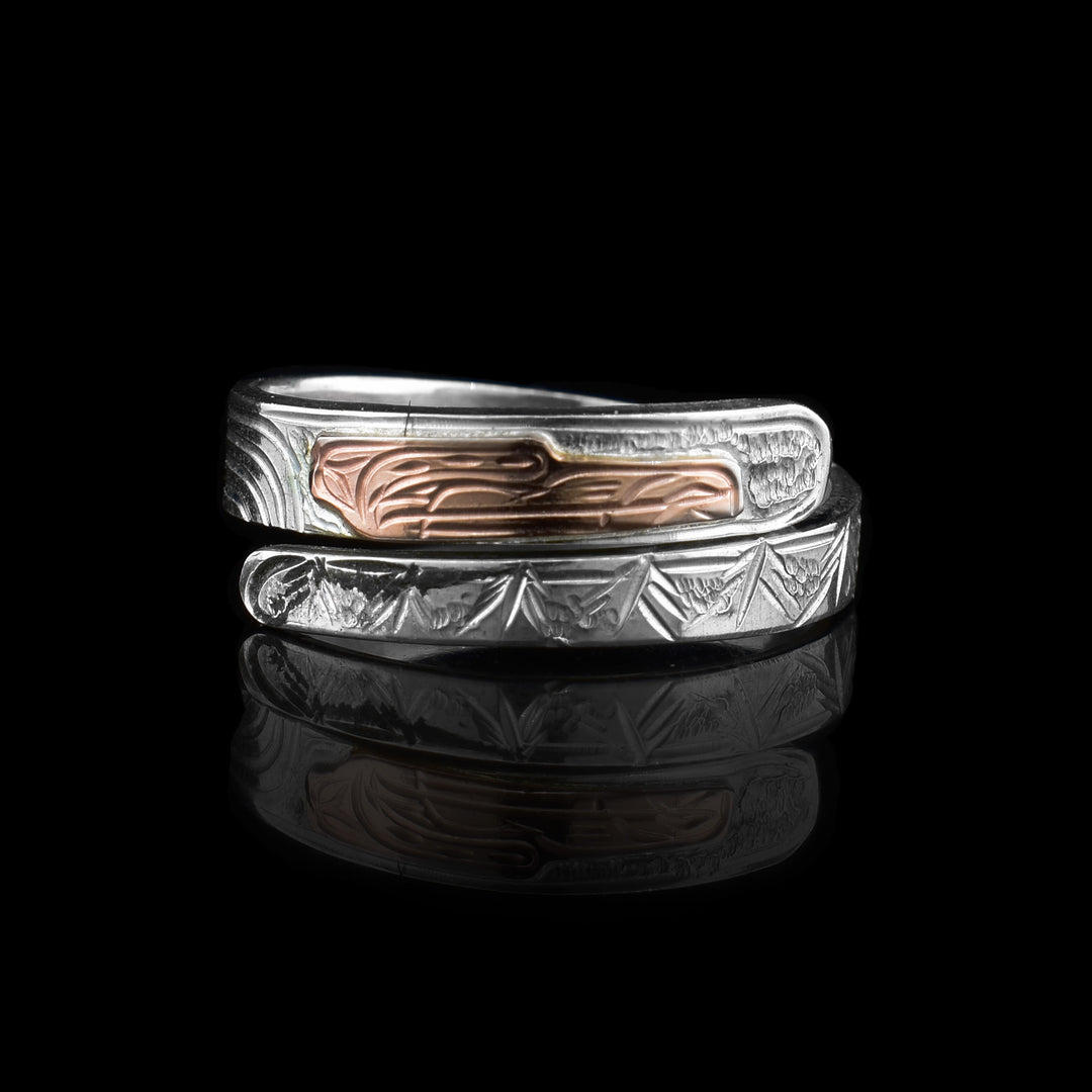 This silver and rose gold bear wrap ring is carved with the legend of the bear. The bears face is carved in copper.