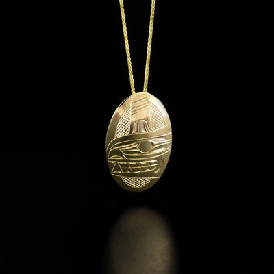 14K Gold Oval Orca Pendant by Harold Alfred. The design depicts the face of an orca with teeth showing and a fin above its head. The background is crosshatched.