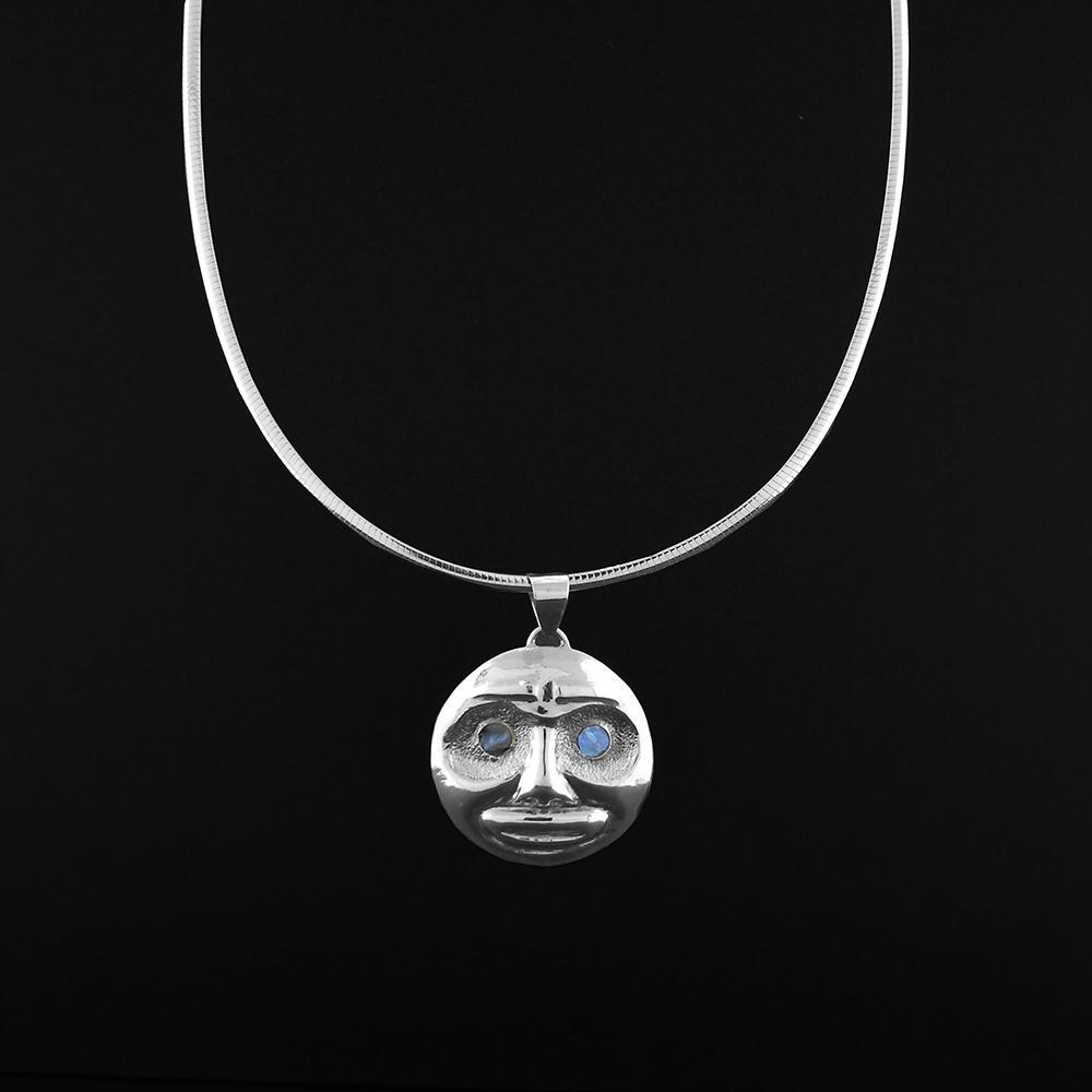 This platinum pendant is made from ablalone gemstone and platinum. The pendant has been repoussed to depict the Moon and has abalone for the eyes.