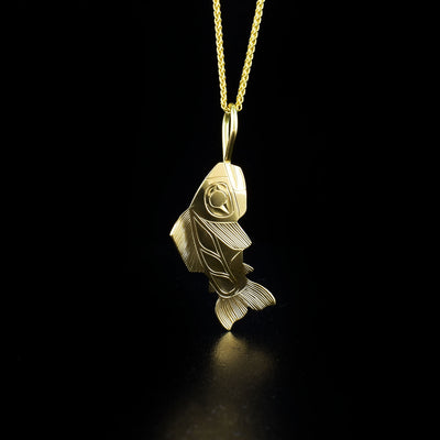 Dazzling salmon pendant hand-carved by Tlingit artist Fred Myra. Made of 14K gold. Pendant measures 1.4" x 0.4" including bail. Chain not included.