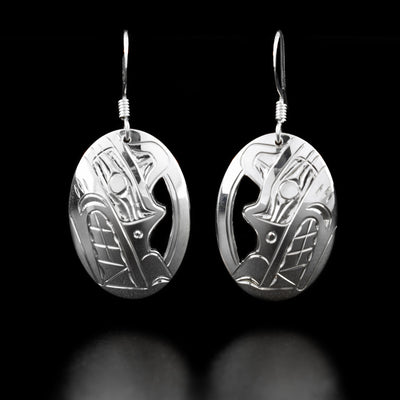 Sterling Silver Oval Wolf Earrings by Harold Alfred. The design depicts the head of a wolf facing downwards with a pointy snout and teeth showing in each earring.