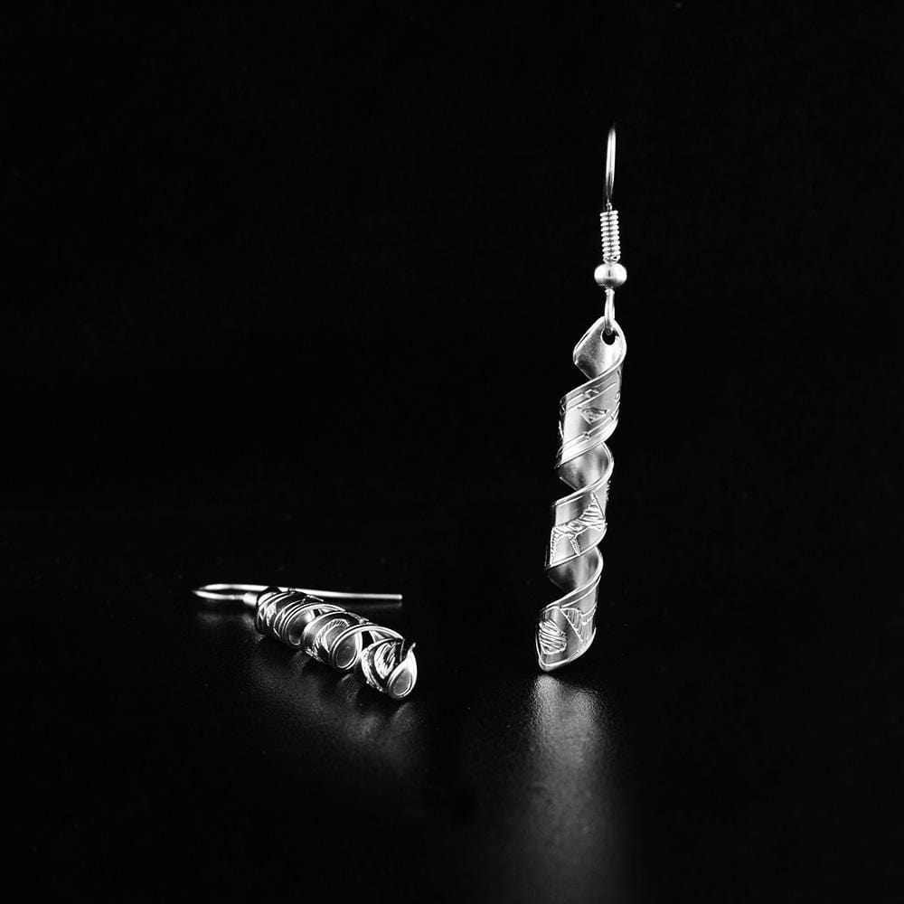 These dangling spiral earrings are made from sterling silver and have long, thin hangs. The hangs are made by coiling bands into an elegant spiral shape. There are depictions of the Orca carved into the surface of the hangs.
