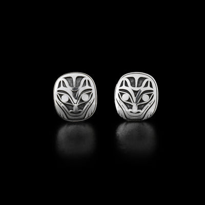 Sterling Silver Wolf Stud Earrings by Grant Pauls. The design depicts the face of a wolf with a long snout and pointy ears. The background has been oxidized for the wolf to stand out.