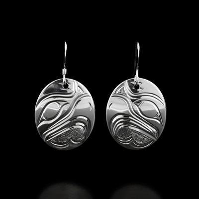 These eagle earrings are oval in shape and have the profile of an eagle's head in the center of each earring facing inward.