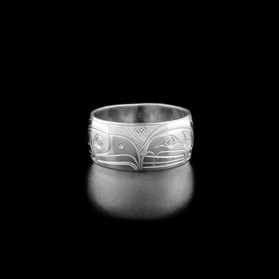 This sterling silver ring has the profile of an eagle's head facing the right and the profile of an orca's head facing the left.