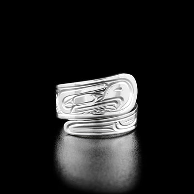 Sterling Silver 3/8" Tapered Thunderbird Wrap Ring by Victoria Harper. The top part of this wrap ring depicts the profile of a thunderbird's head facing towards the right. The thunderbird has a large, pointy beak and a feather on the back of its head. The artist has hand-carved the thunderbird's wing on the bottom part of this wrap ring.