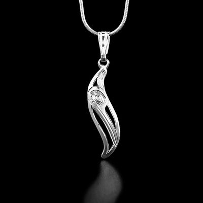 Sterling Silver Leaf Style Hummingbird Pendant by Harold Alfred. This Leaf Style Hummingbird Pendant is in the shape of a leaf. The artist has hand-carved the profile of a hummingbird's head facing towards the right and downward in the center of the pendant. The hummingbird has a small head and a long, narrow beak. The background of the pendant has been cut out.
