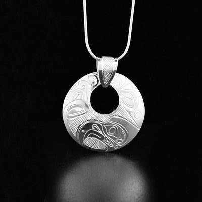 Sterling silver round cut-out eagle pendant with carved bail.