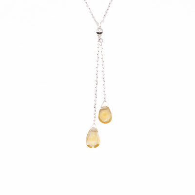 This Citrine Lantern Lariat Necklace is hand crafted by artist Pamela Lauz. The necklace is made from sterling silver with two citrine drops hanging down together.  The necklace measures 17" and the lariat hangs down 2" (5cm).