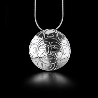 This Small Moon Pin Pendant was handmade by Kwakwaka'wakw artist, John Lancaster. He has used sterling silver to create this piece.  This piece measures 1.22" in diameter. The chain is not included. The Moon Legend Represents: TRANQUILITY, GUIDANCE, PROTECTOR.