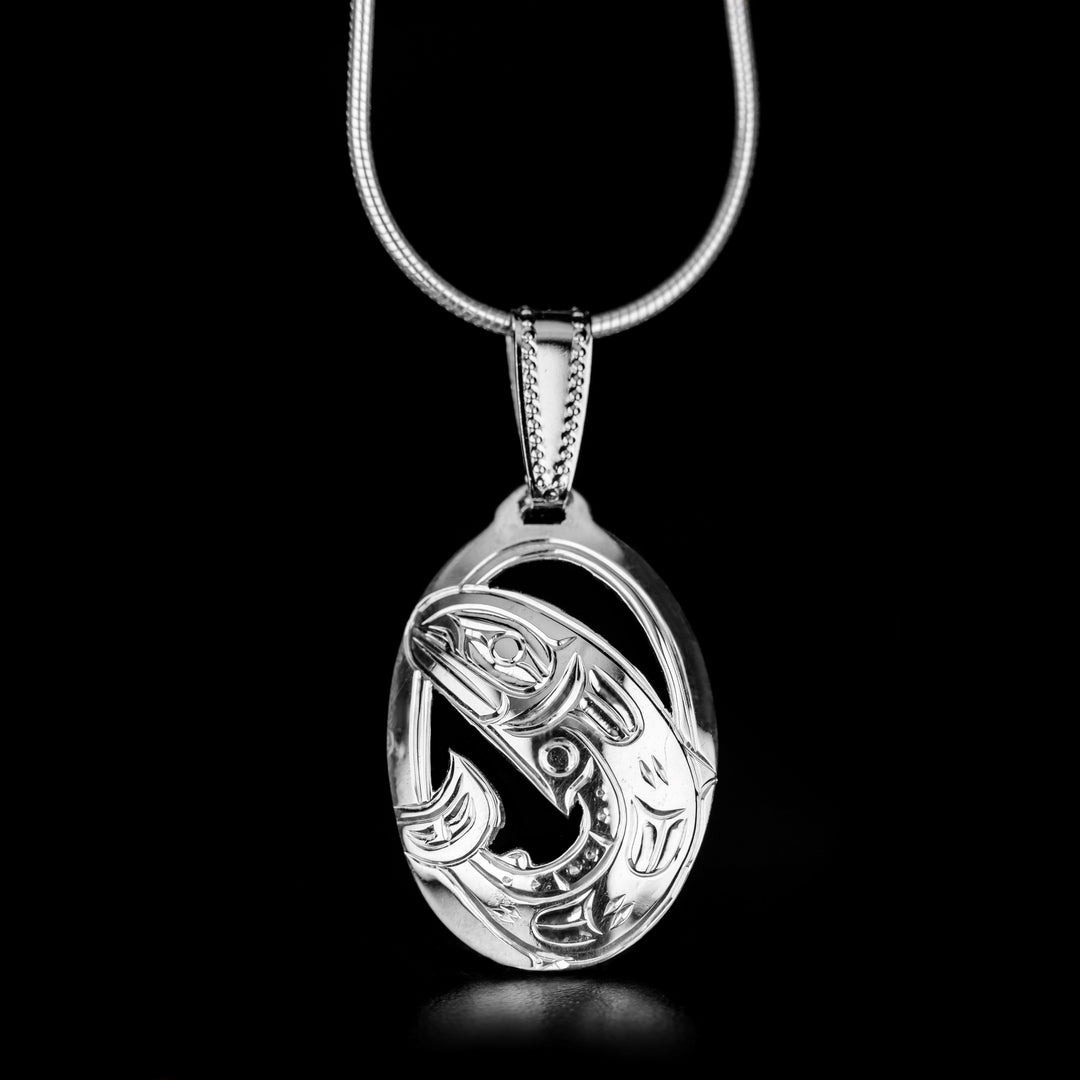 This Small Oval Salmon Pendant is handmade by Kwakwaka'wakw artist, Harold Alfred. He has used sterling silver to create this piece. The pendant measures 1.38" x 0.67". The chain is not included. The Salmon Legend Represents: REBIRTH, SELF-SACRIFICE, DETERMINATION.