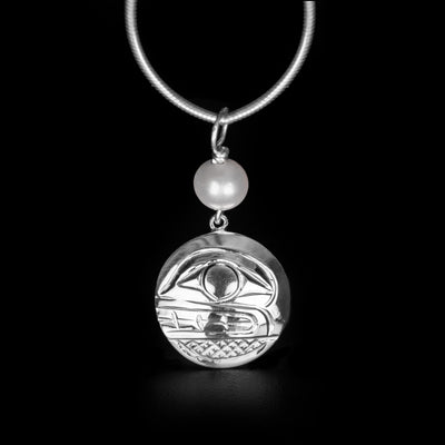 This Round Orca Pendant with Pearl is handmade by Kwakwaka’wakw artist, Carrie Matilpi. She has used sterling silver for the orca and a freshwater pearl. The pendant measures 1.22" x 0.65" including the bail. The chain is not included. The Orca Legend Represents: LONGEVITY, PROTECTION, FAMILY.