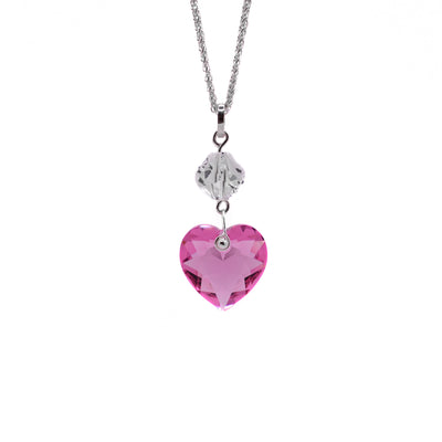 This crystal heart pendant has two crystals. The bottom is heart-shaped and pink in colour. It is attached to a round, clear crystal above through a silver loop. 