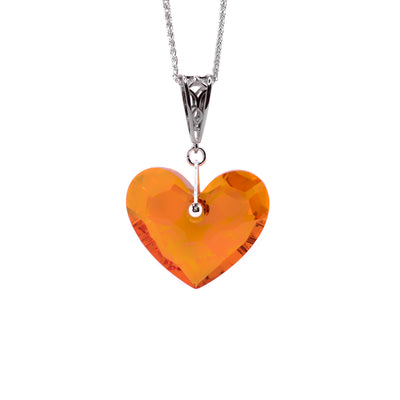 This crystal heart pendant is heart-shaped and is mainly orange in colour. It has a small hole at the top for the carved bail to go through.