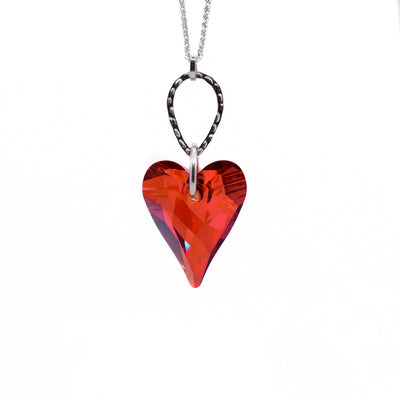 This crystal heart pendant is heart-shaped and red in colour. The bail is made up of 3 silver hoops varying in sizes.