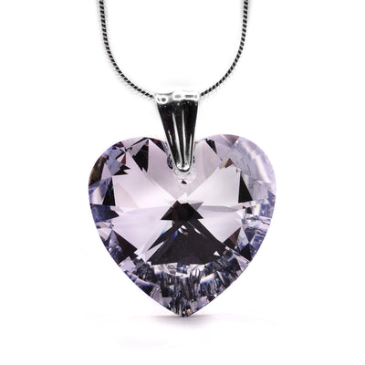 Comet Swarovski Crystal Heart Pendant by Debra Nelson. The Swarovski crystal has been cut out into a heart shape. The artist has then handcrafted the bail and attached it to the top of the heart. The Swarovski crystal is clear.