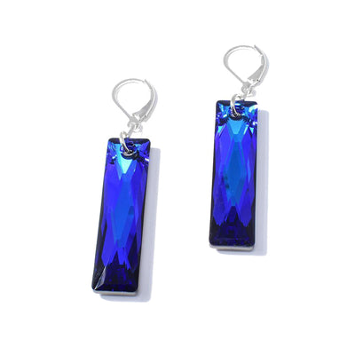 These Bermuda Blue Queen Baguettes Earrings are by artist Karley Smith. She has used sterling silver and Swarovski Crystal to create them. Each earring measures 2.25" x 0.38".