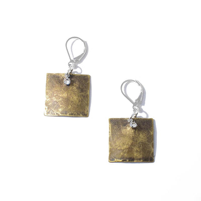 These Bronze and Swarovski Crystal Earrings are handcrafted by artist Karley Smith. She has used bronze, sterling silver, and Swarovski crystal to create them.  Each earring measures 1.25" x 0.81" from the top of the hook.