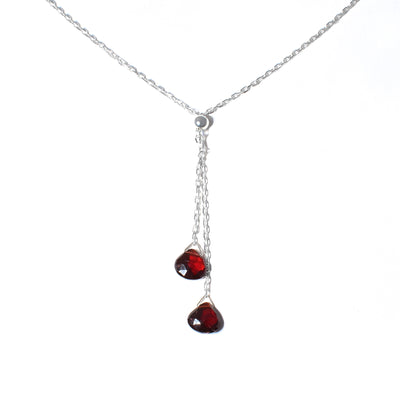 This Garnet Lantern Lariat Necklace is hand crafted by artist Pamela Lauz. The necklace is made using sterling silver and genuine garnet.  The necklace is 17" long and the lariat hangs down an additional 2.25".
