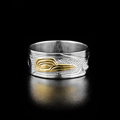 14K Gold and Sterling Silver 3/8" Hummingbird Ring by Victoria Harper. The design depicts the head of a hummingbird facing the right made out of 14k gold in the center of the ring. On both sides of the head the artist has hand carved intricate designs representing the hummingbird's body and wings using sterling silver.