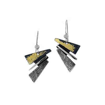 These oxidized silver earrings have abstract triangular shapes stacked on top of one another. The top triangle is black and gold in colour with the rest being silver.