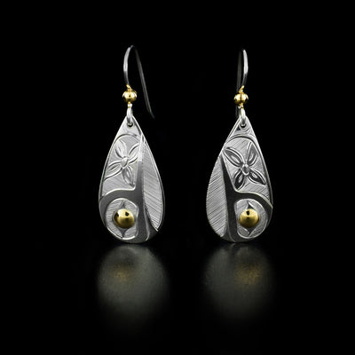 These 14K Gold and Sterling Silver Hummingbird Teardrop Earrings are hand-carved by Haisla artist, Hollie Bartlett.   She has used sterling silver to create this piece and has added 14K gold accents to each earring.  Each earring measures 1.5" x 0.5", including the hook.      The Hummingbird Legend Represents: BEAUTY, LOVE, HARMONY.