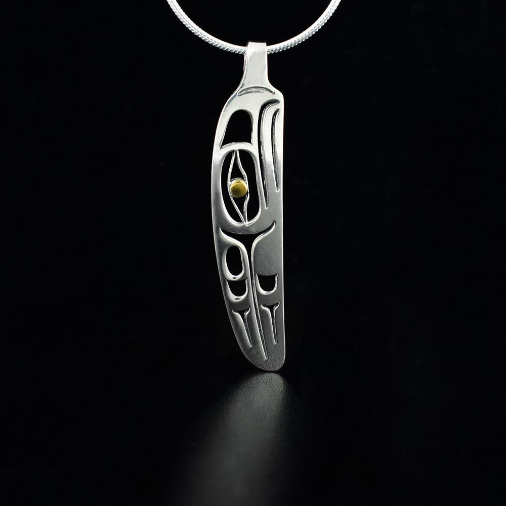 This Eagle feather pendant is made from sterling silver and 18K gold. The pendant is feather shaped and has cutout designs that depict the Eagle.