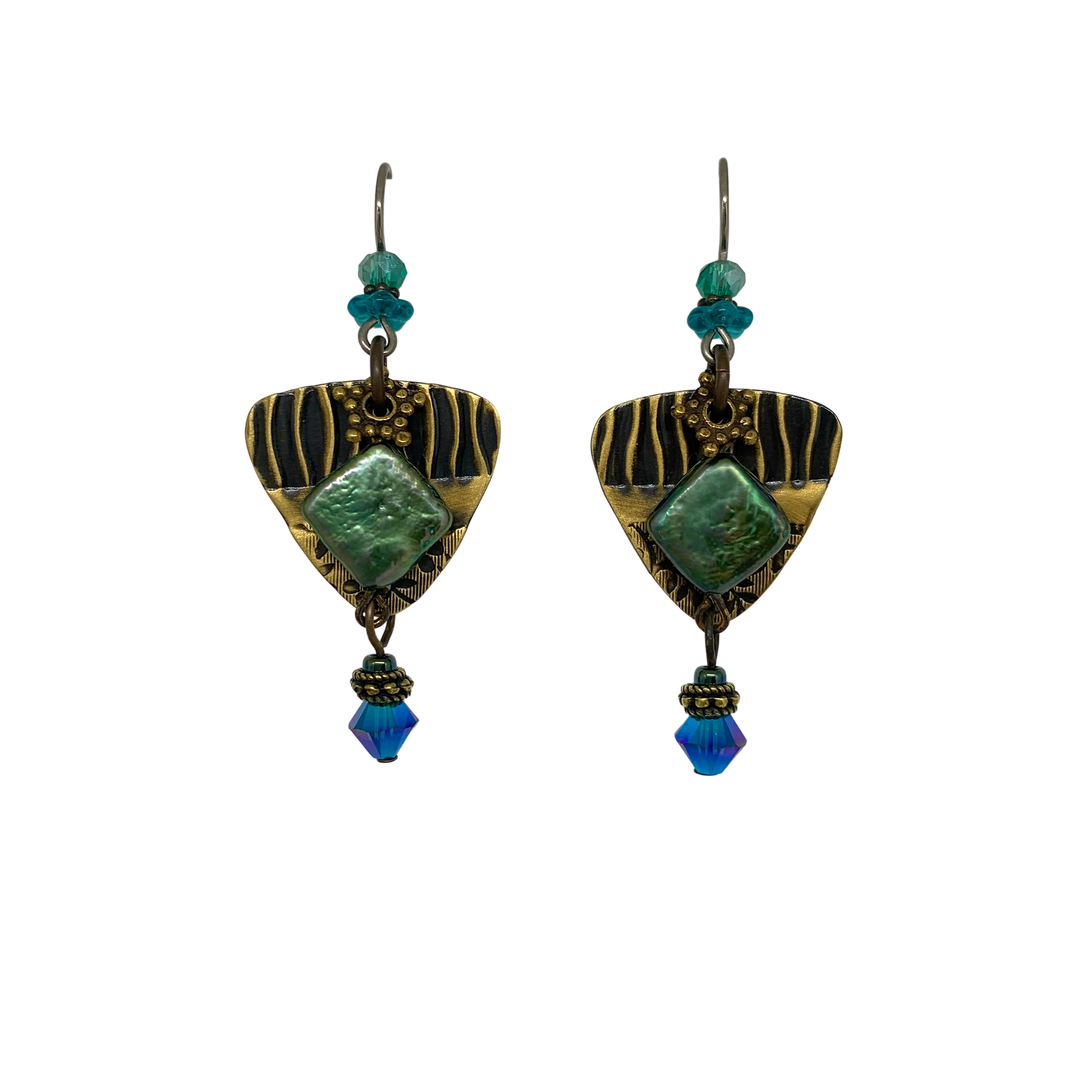 These unique dangling pearl and crystal earrings are made from Swarovski Crystal, Hand worked Brass, Freshwater Pearls, and Pressed Glass. There are brass, triangle hangs with a gemstone in the center and has many small bead of various materials. The beads dangle below it and on the hooks.